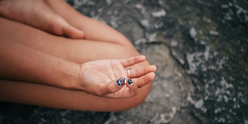 Detail of a person hands in a mudra position